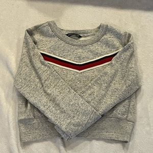 Gray long sleeve sweater with navy blue white and red triangle stripe